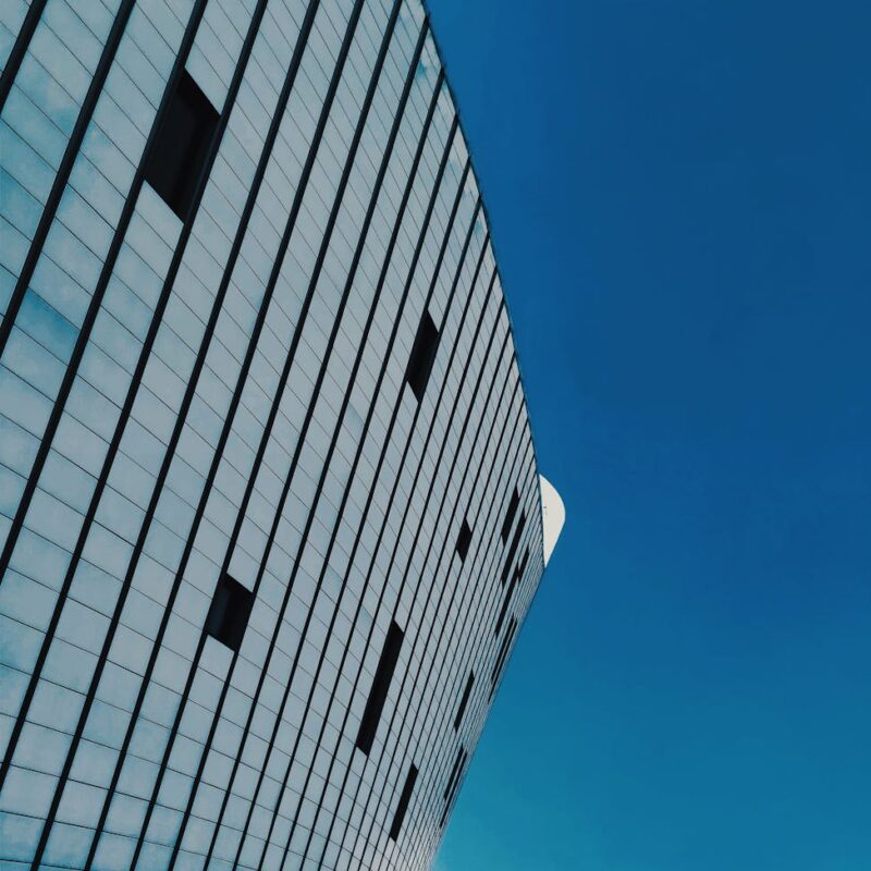 Detailed view of a modern urban building with blue sky in the background.