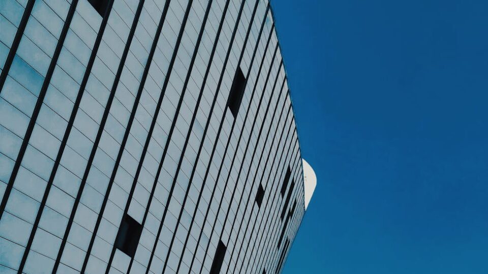 Detailed view of a modern urban building with blue sky in the background.